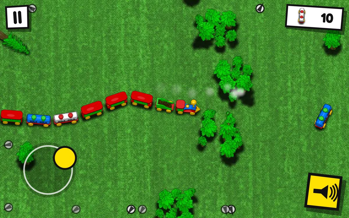 The train driving across the meadow between trees